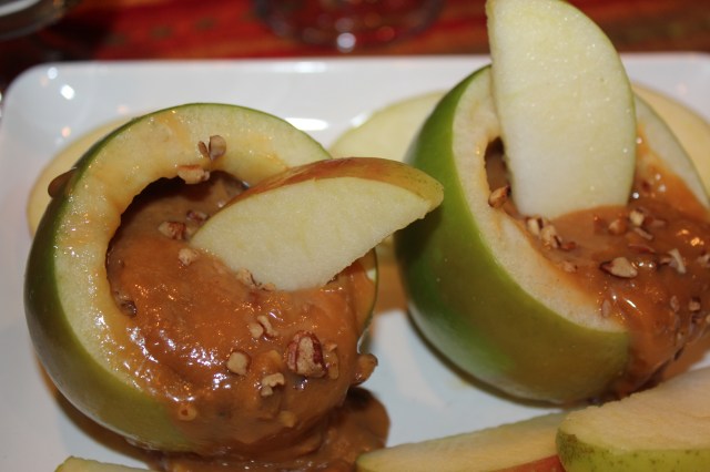 Dipping apple slices in caramel sauce
