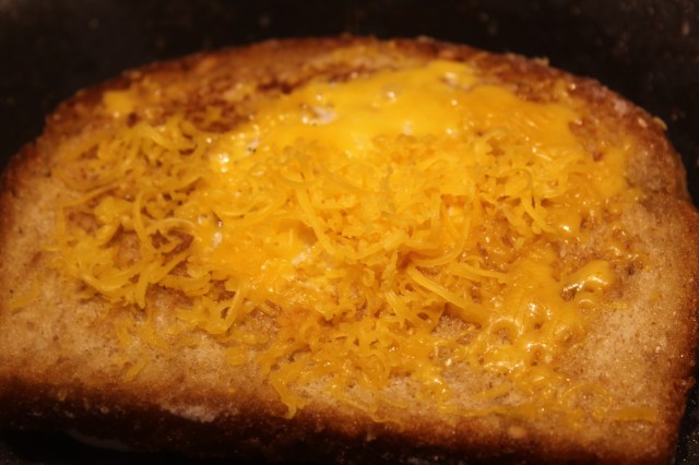 Sprinkle egg and bread with cheese