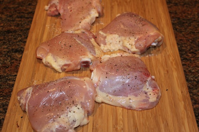 Season chicken thighs for Kel's lemon chicken soup