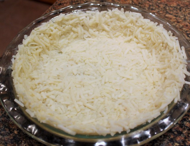 Press hash browns on pie plate