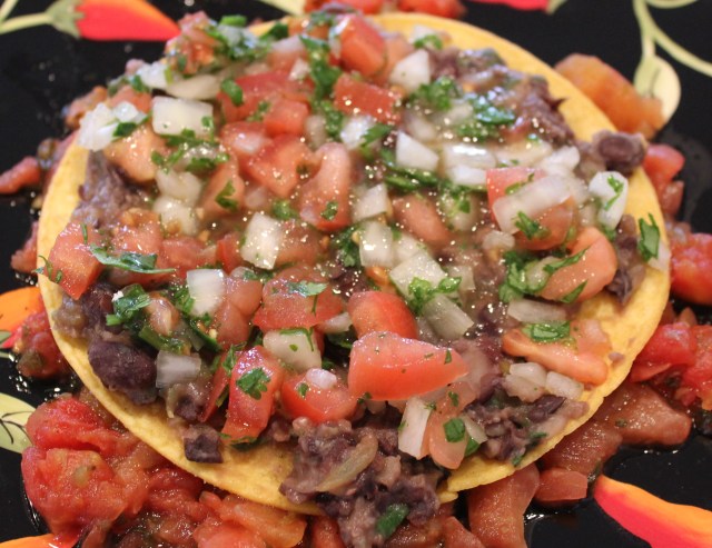 Start layering the huevos ranchereos ingredients