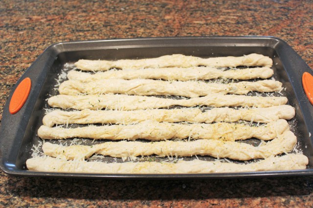 Brush breadsticks with egg white and sprinkle with cheese and garlic powder