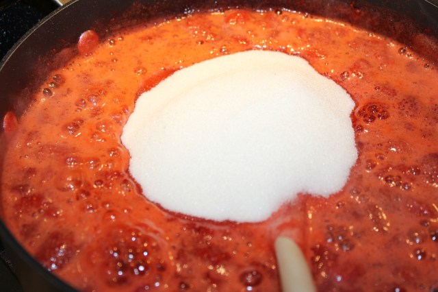 Add sugar to smushed strawberries