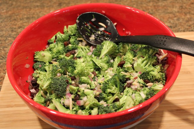 Mix together broccoli, almonds, raisins, onion, lemon juice