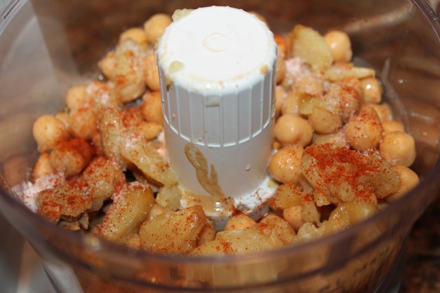 Add seasonings to Kel's garlic humnmus