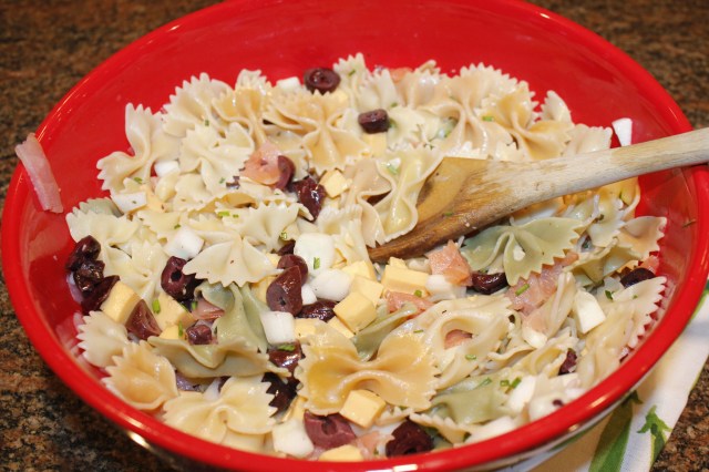 Mix together pasta, cheese, olives, chives, salmon, etc.