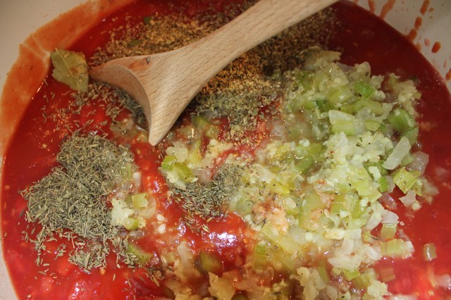 Add spices, celery, etc. to tomatoes
