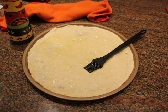 Brush dough with olive oil