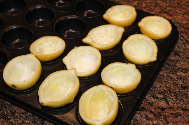 Place scooped lemons in muffin pan