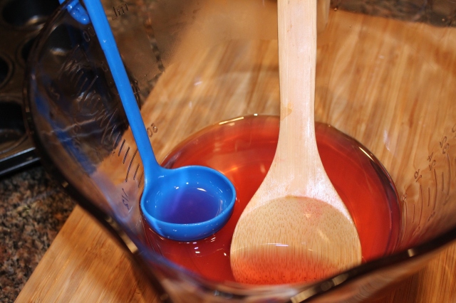 Use a ladle to fill lemons with lemonade mixture