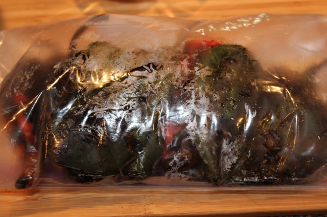 Charred Poblanos steaming in plastic bag