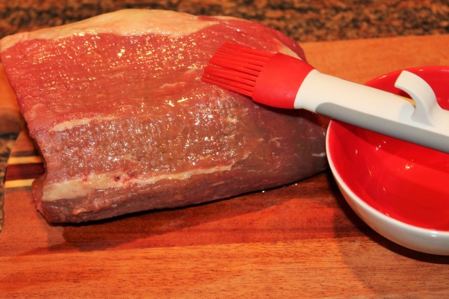 Brush oil on eye round roast