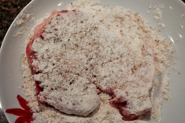 Dredge pork chop in seasoned flour