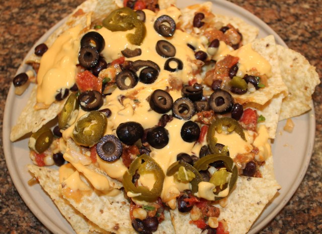 Layer nachos with filling, queso, etc.