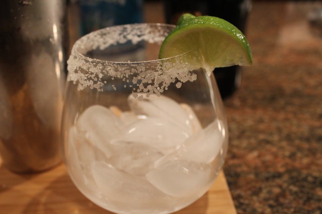 Rim glass with salt and add ice