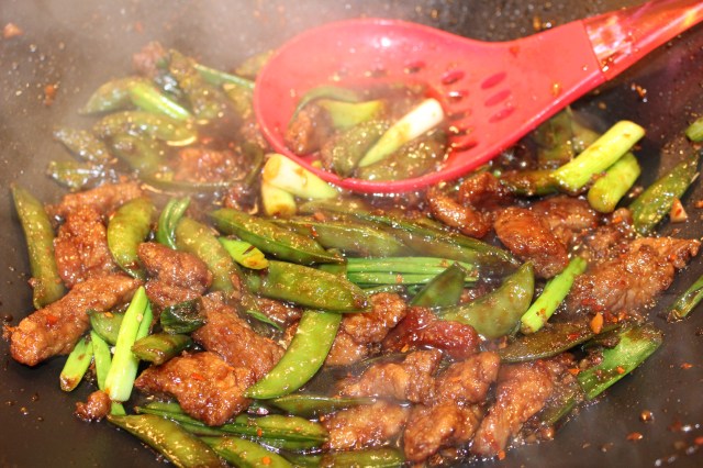 Add green onions and season with red pepper flakes
