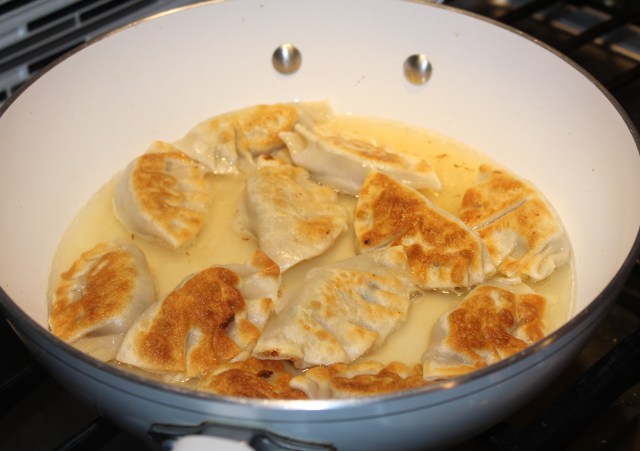add-chicken-stock-to-pot-stickers