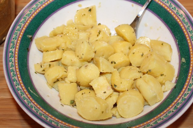 Toss potatoes with dressing