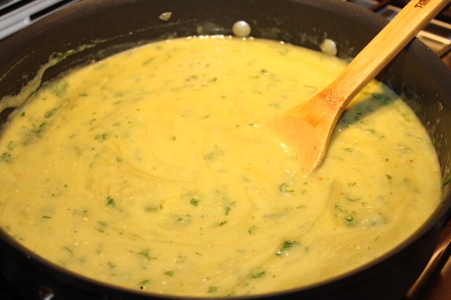Add cilantro and enchilada sauce to pureed tomatillos
