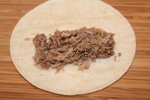 Place pork on corn tortilla
