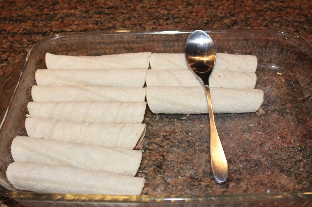 Roll up tortillas and place in casserole dish