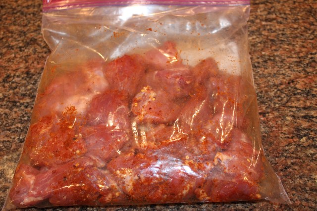 Season pork in plastic bag