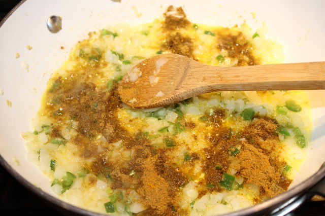 Add spices to sauteed onions