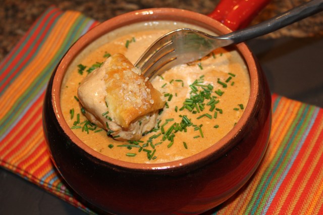 dip pretzel bit in beer cheese dip